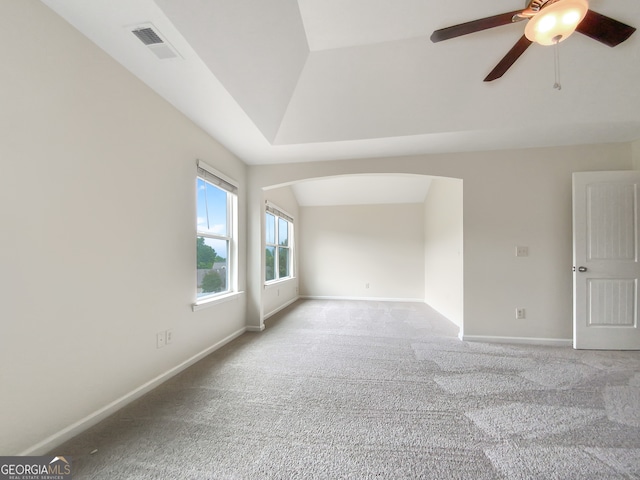 unfurnished room featuring vaulted ceiling, ceiling fan, and carpet floors