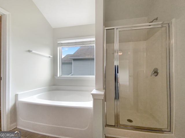 bathroom featuring vaulted ceiling and separate shower and tub