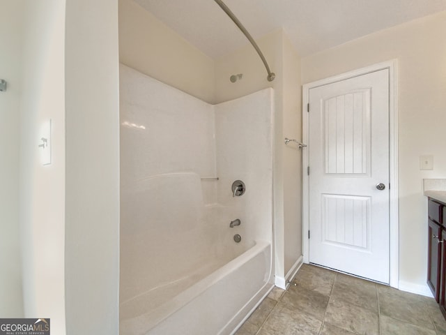 bathroom with shower / bathtub combination, tile floors, and vanity