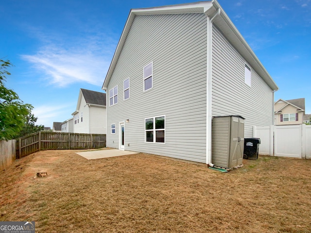 rear view of property with a patio and a lawn