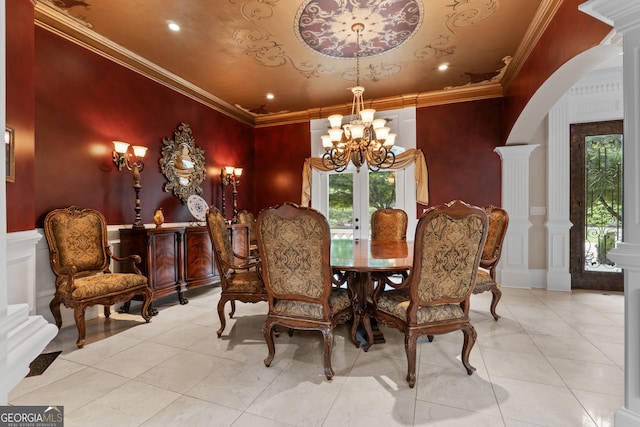 dining area with ornamental molding, decorative columns, and light tile flooring