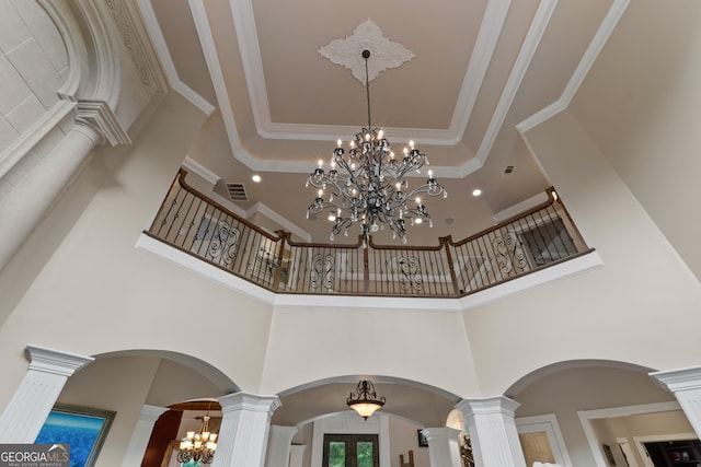 details featuring an inviting chandelier, ornamental molding, and decorative columns