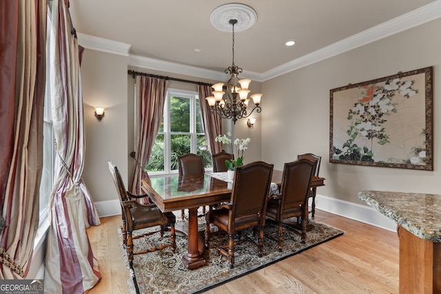 dining room featuring a chandelier, ornamental molding, and wood-type flooring