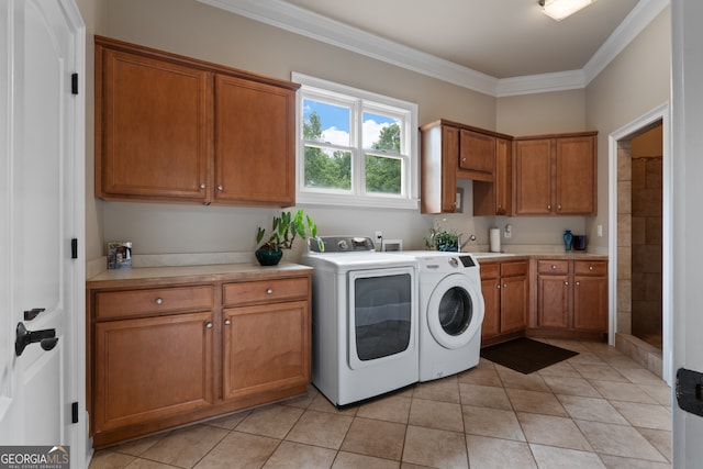 laundry area with washer hookup, light tile floors, ornamental molding, separate washer and dryer, and cabinets