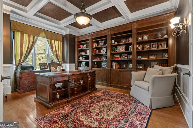 office space featuring hardwood / wood-style floors, built in features, coffered ceiling, and crown molding