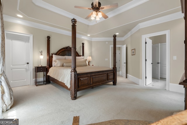 bedroom with ceiling fan, a raised ceiling, light carpet, and ornamental molding