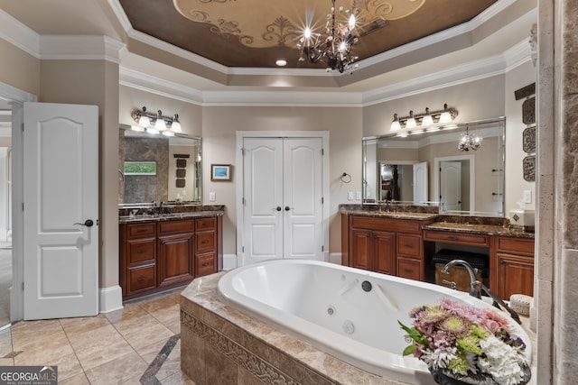 bathroom featuring an inviting chandelier, a raised ceiling, tile flooring, ornamental molding, and vanity