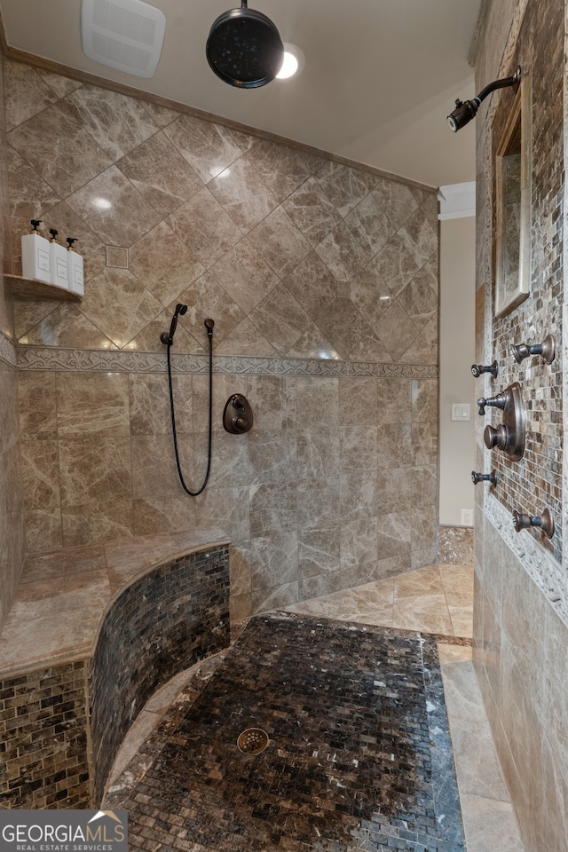 bathroom featuring tile floors and tiled shower