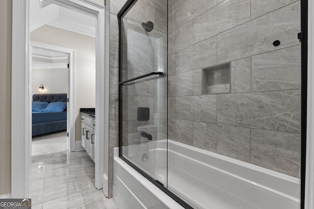 bathroom with tile flooring, enclosed tub / shower combo, vanity, and crown molding