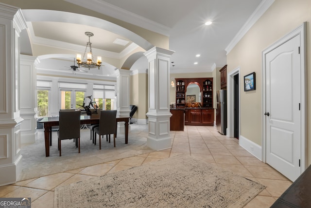 dining space with ornamental molding, decorative columns, light tile floors, and ceiling fan with notable chandelier