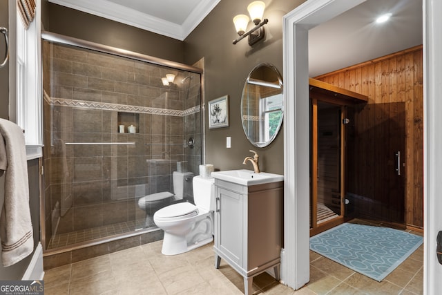 bathroom with walk in shower, crown molding, toilet, and tile floors