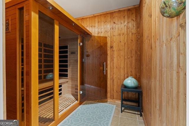 view of sauna / steam room with tile floors and wooden walls