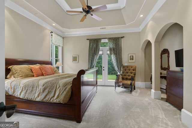 carpeted bedroom featuring access to outside, ceiling fan, a raised ceiling, crown molding, and french doors