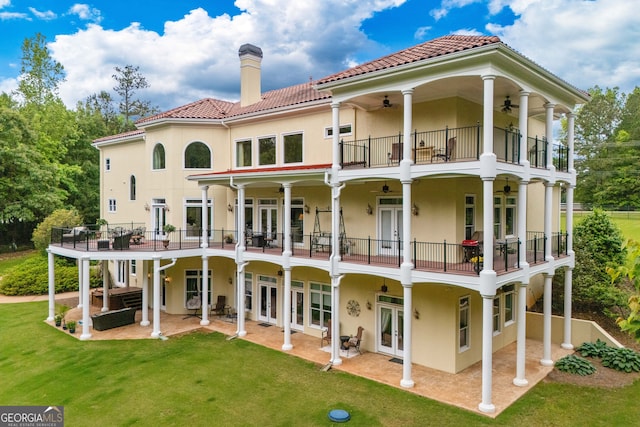 back of house with a patio, french doors, a balcony, a yard, and ceiling fan