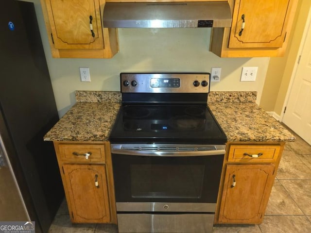 kitchen with extractor fan, light tile patterned floors, light stone countertops, and appliances with stainless steel finishes