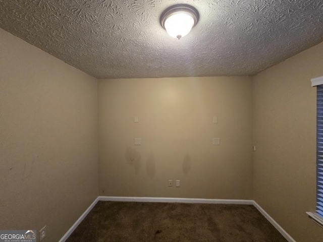 carpeted spare room featuring a textured ceiling