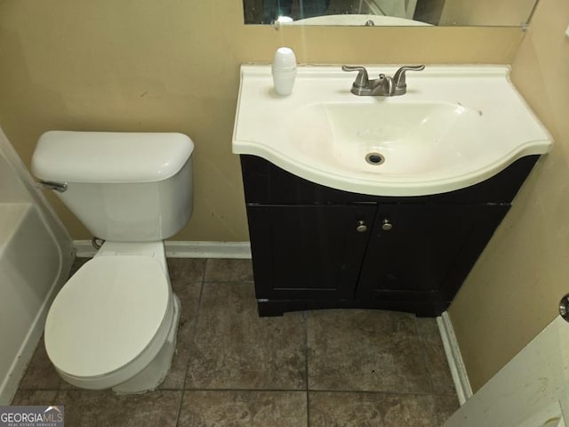 bathroom featuring vanity, tile patterned flooring, and toilet