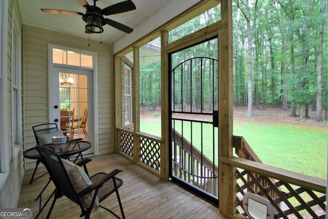 sunroom with plenty of natural light and ceiling fan