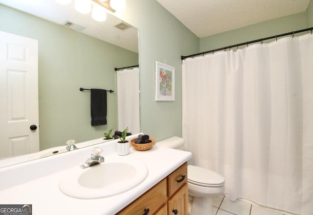 bathroom featuring tile floors, a textured ceiling, vanity, and toilet