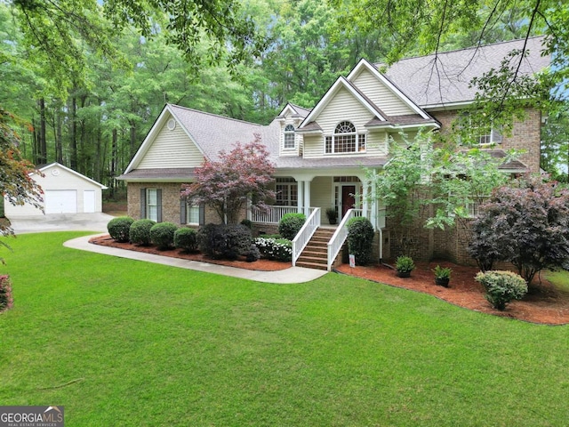 view of front of house featuring a porch, an outdoor structure, a garage, and a front lawn