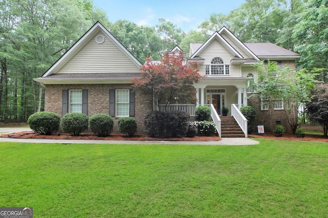 view of front of home featuring a front yard and covered porch