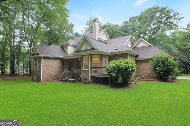 rear view of house with a lawn