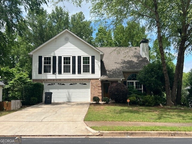 view of front of house with a front yard and a garage