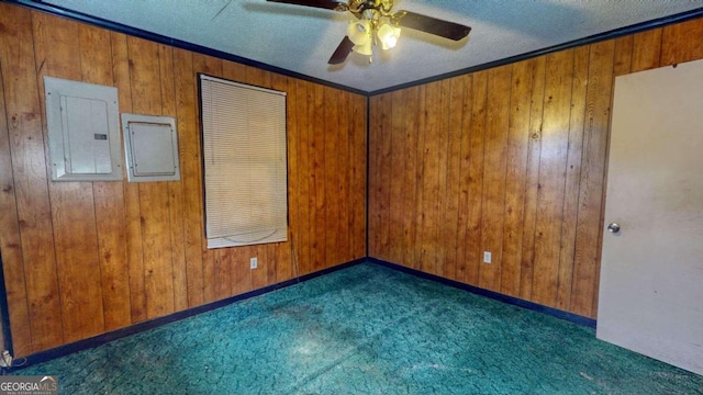 unfurnished room featuring wooden walls, dark colored carpet, and ceiling fan