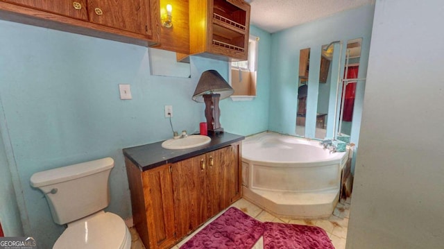 bathroom with tile floors, a textured ceiling, toilet, and vanity