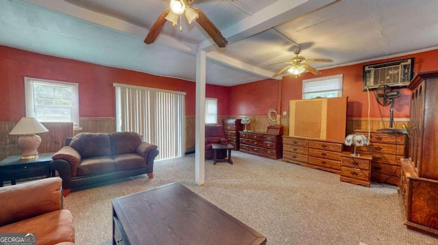 carpeted living room featuring beam ceiling, ceiling fan, and an AC wall unit