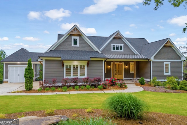 craftsman inspired home with a garage, a front lawn, and covered porch