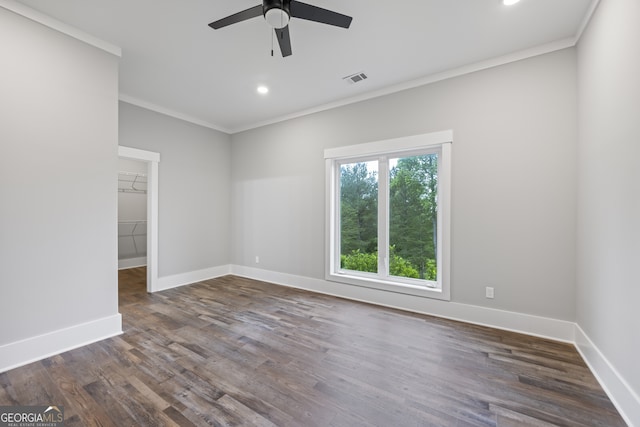 spare room featuring dark hardwood / wood-style flooring, a wealth of natural light, and ceiling fan