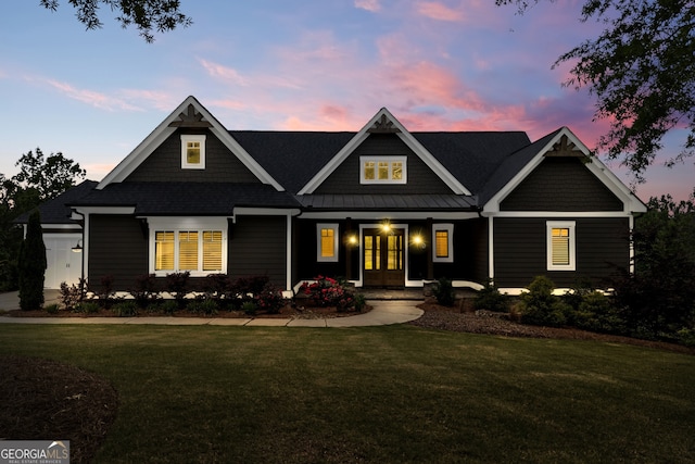 craftsman inspired home featuring covered porch and a yard