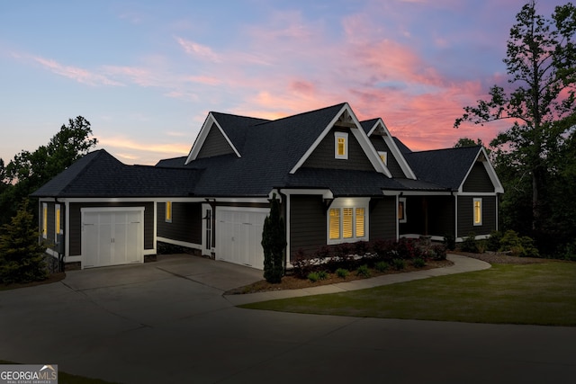 view of front of property featuring a garage and a yard