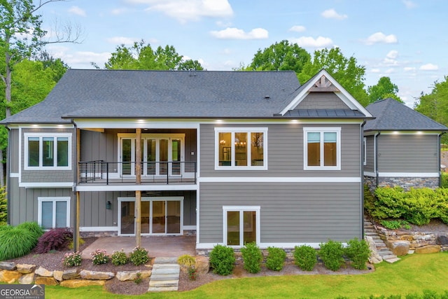 back of house featuring a balcony and a patio area