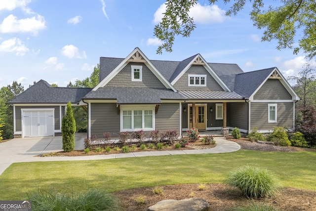 craftsman inspired home featuring a garage and a front lawn