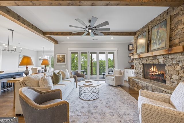 living room with beam ceiling, a fireplace, ceiling fan with notable chandelier, and dark hardwood / wood-style flooring