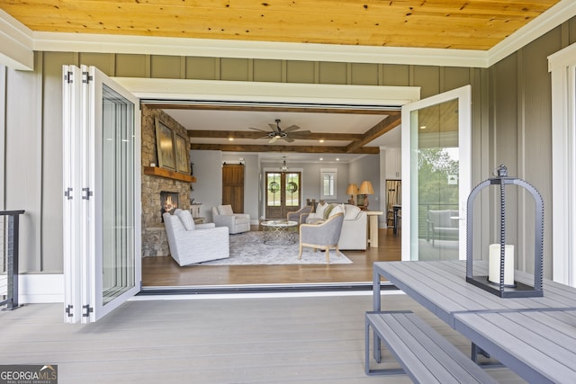 wooden terrace featuring ceiling fan