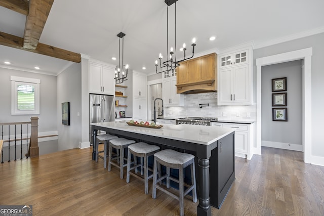 kitchen with white cabinetry, custom exhaust hood, an island with sink, and dark wood-type flooring