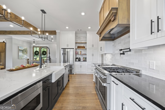 kitchen featuring white cabinetry, pendant lighting, light hardwood / wood-style flooring, and stainless steel appliances