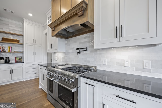 kitchen featuring white cabinets, double oven range, premium range hood, backsplash, and dark hardwood / wood-style floors