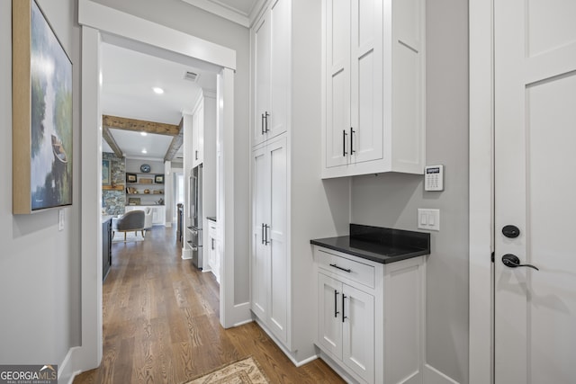 interior space featuring light hardwood / wood-style floors and ornamental molding