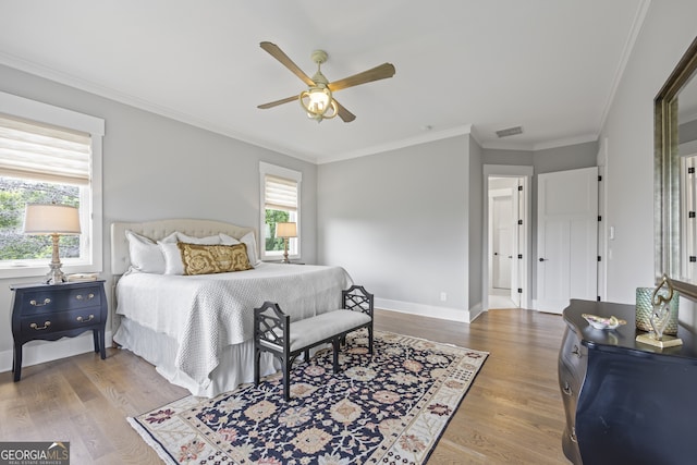 bedroom with ornamental molding, ceiling fan, and hardwood / wood-style floors