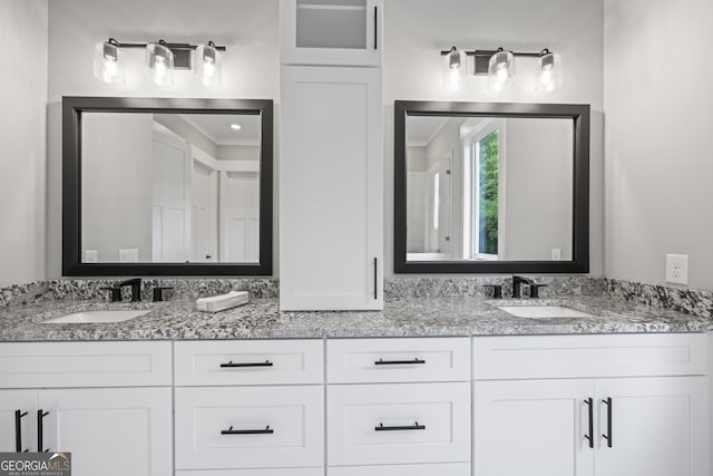 bathroom with dual bowl vanity and ornamental molding