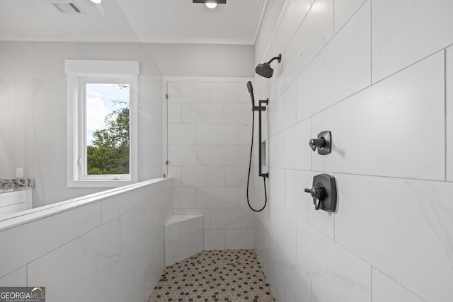 bathroom with tiled shower and ornamental molding