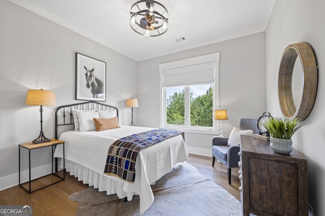 bedroom featuring hardwood / wood-style flooring and ornamental molding