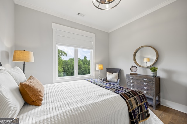 bedroom featuring wood-type flooring and ornamental molding