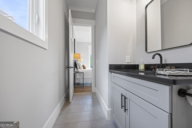 bathroom with hardwood / wood-style flooring, a healthy amount of sunlight, and vanity