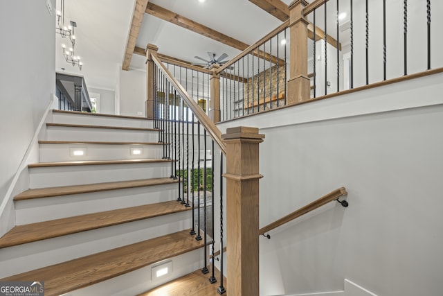 stairway featuring wood-type flooring and ceiling fan