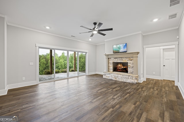 unfurnished living room with ceiling fan, a fireplace, crown molding, and dark wood-type flooring